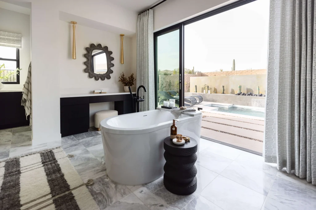 Luxury bathroom with freestanding tub and pool view