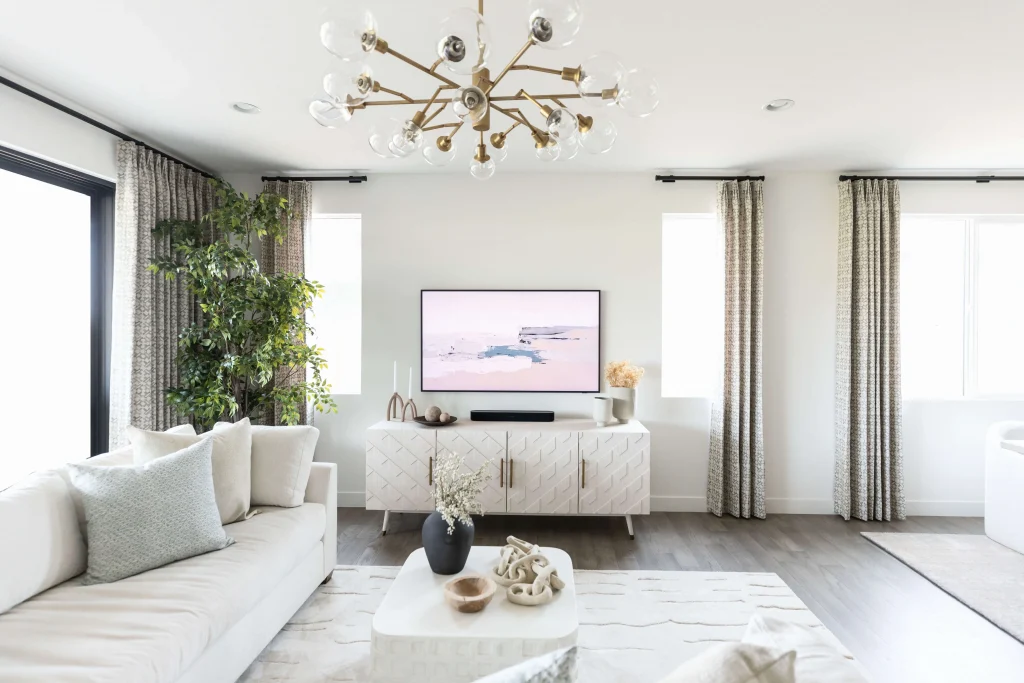 Bright living room with white furnishings and gold chandelier
