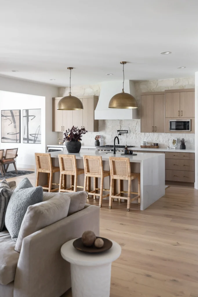 Open kitchen with bar stools and sofa