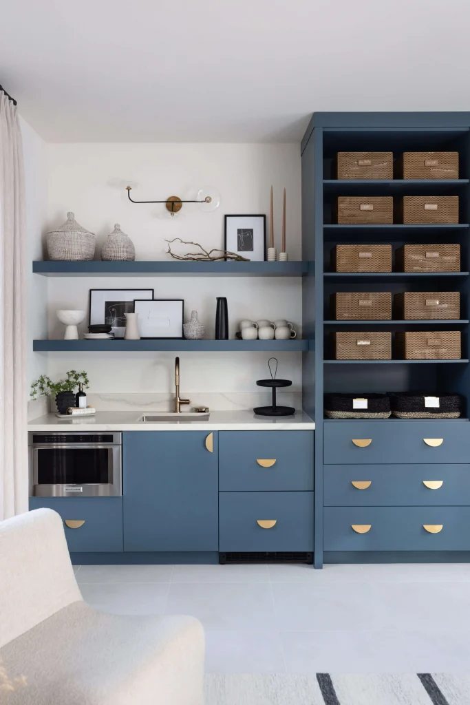 Built-in cabinetry with brass hardware and open shelving