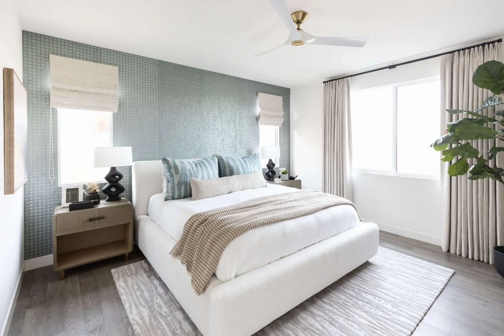 Bedroom with patterned accent wall and cozy decor