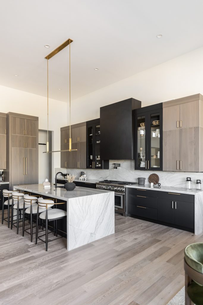 Spacious kitchen with marble island and stools