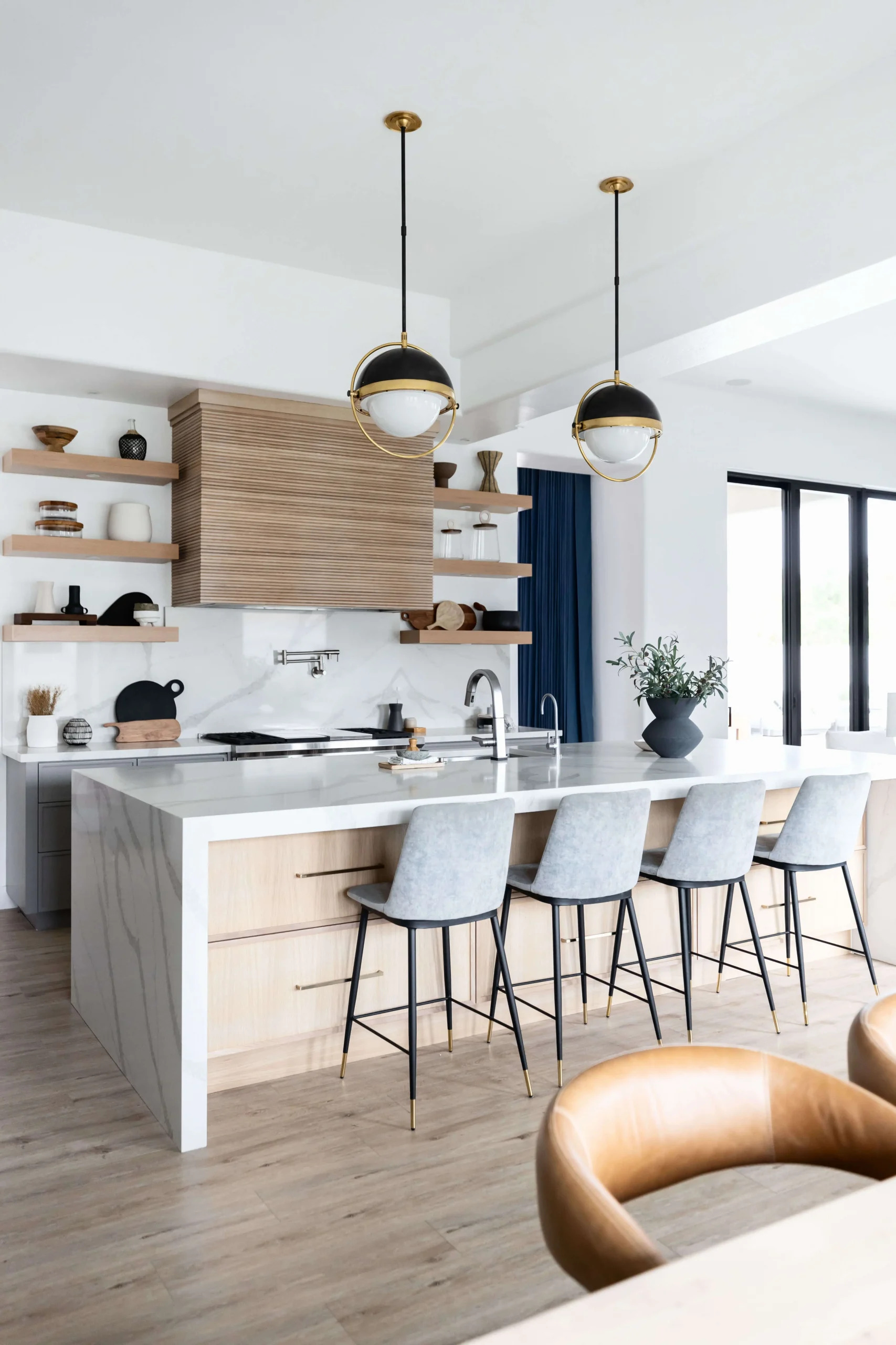 Modern kitchen with marble island and bar stools