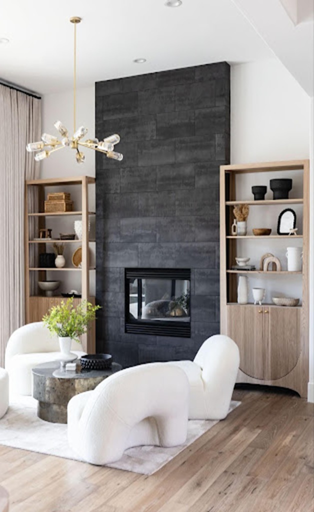 Modern living room with black fireplace and white lounge chairs