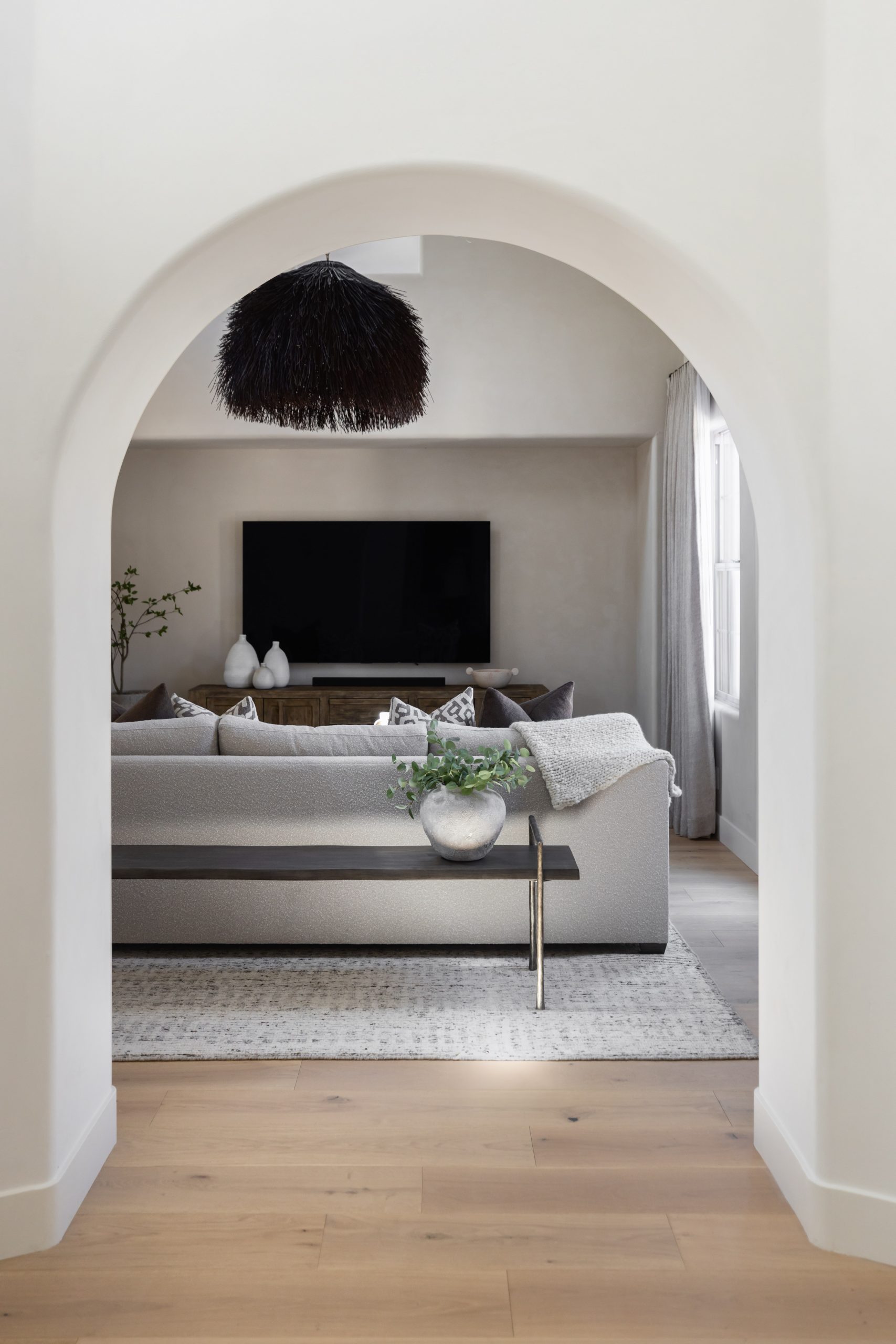 Modern living room with black fireplace and white lounge chairs