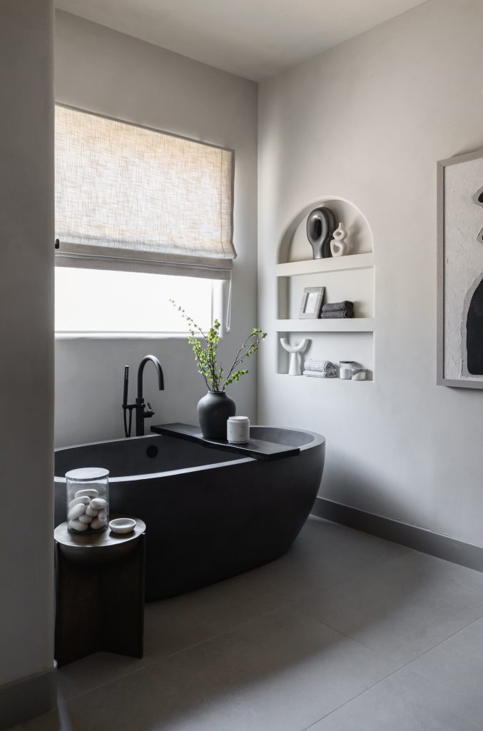 Minimalist bathroom with black tub